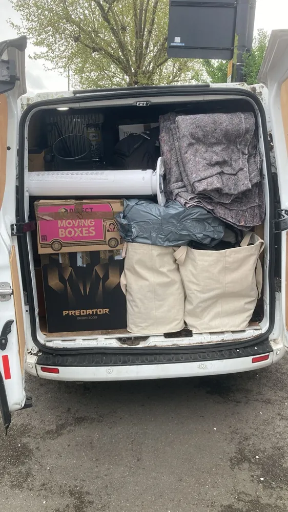 A van loaded with moving boxes and bags