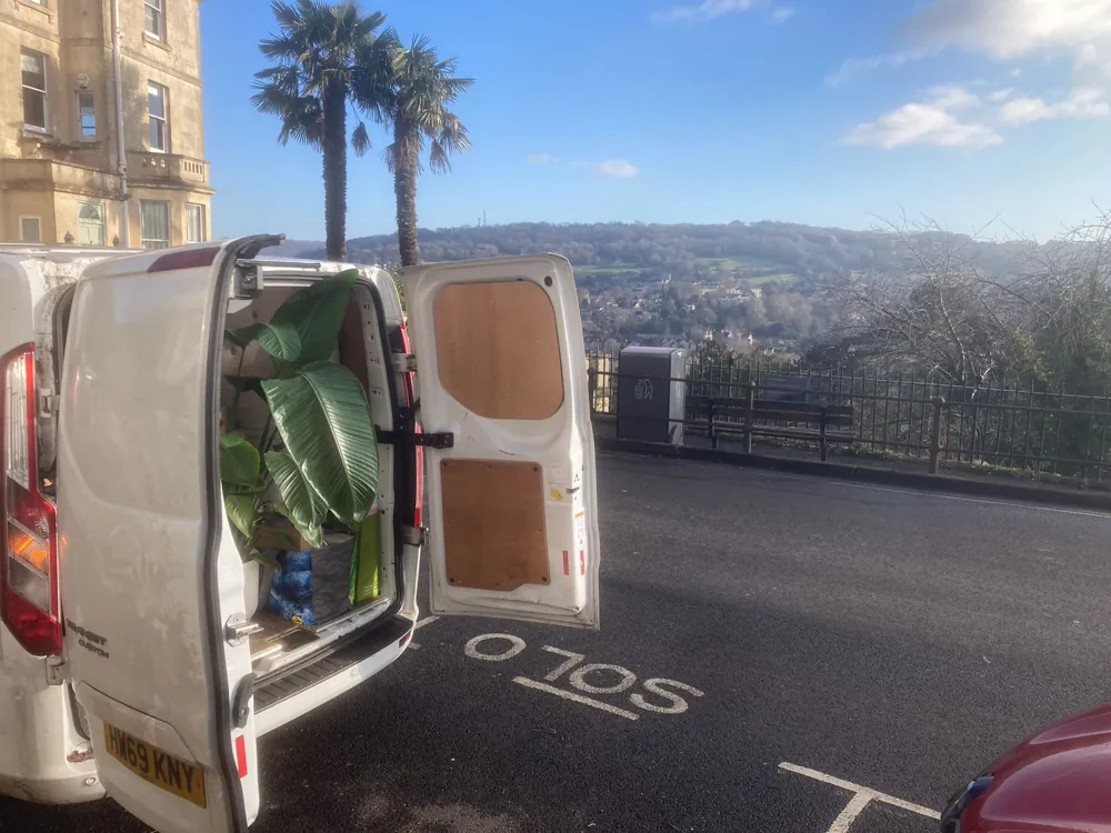 A van loaded with house plants, overlooking Bath